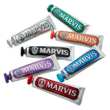 Multiple tubes of Marvis toothpaste in various flavors on a white background